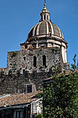 Catania - Catania - the dome of the cathedral, the merloned black lava stone walls of the transept. 