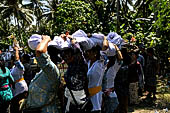 Cremation ceremony - Held over everyone's heads, the corpse is led by the kajang and placed inside the coffin.