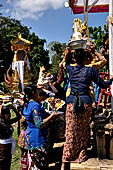 Cremation ceremony - Family members then passes ritual items up to be placed on the coffin. 