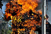 Cremation ceremony - The fuel ignites under the pyre and the splendid tower - coffin, offerings, decorations - is engulfed in flames.