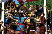 Cremation ceremony - Family members then passes ritual items up to be placed on the coffin. 