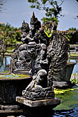 Tirtagangga, Bali - Detail of the statues around the fountain tower in the middle of the garden.