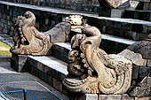 Borobudur - Makara head with a lion in its mouth flanking one of the stairways leading up to the monument. 