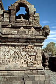 Borobudur - Buddha statues set in its own niche and pinnacles atop the balustrades of the lower four terraces. 