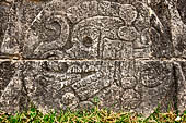 Chichen Itza - Great Ball court. Detail of the bas-reliefs on the side benches. A skull inside the ball marks the canter of the panel. 