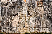 Chichen Itza - Great Ball court. Detail from the east panel.   a figure at left holding a severed head, in the centre a ball decorated with a human skull. To the right spurts of blood shown in the form of six serpents gush from a decapitated player. 