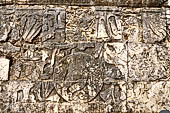 Chichen Itza - Great Ball court. Detail of the bas-reliefs on the side benches. This detail shows at left a decapitated figure with spurts of blood shown in the form of six serpents, in the centre there is the ball decorated with a human skull.  