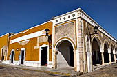 Izamal - low Spanish colonial houses, most of the buildings facades are painted a glowing ochre colour.