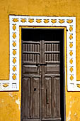 Izamal - low Spanish colonial houses, most of the buildings facades are painted a glowing ochre colour.