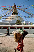 Bodhnath - Pilgrims circumambulate the external wall surrounding the stupa with 147 prayer wheels.  