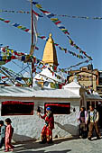 Bodhnath - Pilgrims circumambulate the external wall surrounding the stupa with 147 prayer wheels. 