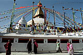 Bodhnath - Pilgrims circumambulate the external wall surrounding the stupa with 147 prayer wheels. 