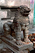 Kathmandu - Stone lions at the entrance of Musya Bahal.