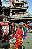 Kathmandu - from Asan Tole to Durbar Square. Lunchun Lunbun Ajima temple with erotic images on the roof struts.