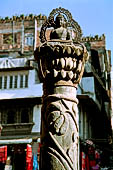 Kathmandu - Buddha statue on pillar in front of Seto (white) Machhendranath temple.