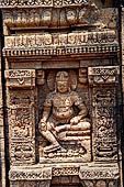 Ratnagiri - the main monastery - at the side of the entrace portal the image of Kubera, the guardian of buried treasure, as indicated by the pots beneath his throne. 