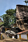 Aluvihara cave temples - The caves temples linked by flights of steps and narrow paths in a jumble of massive rock boulders. 