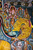 Aluvihara cave temples - Cave 1. Details of the dragon arch overhead of the Buddha with the face of the 'Kibihiâ' and Hindu gods. 