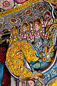 Aluvihara cave temples - Cave 1. Details of the dragon arch overhead of the Buddha with the face of the 'Kibihiâ' and Hindu gods. 