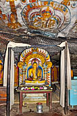 Dambulla cave temples - Cave 4, Paccima Viharaya (Western Temple). Buddha figure sits under an elaborate makara torana arch.  