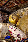 Dambulla cave temples - the narrow Cave 1, Devaraja Viharaya (Temple of the Lord of the Gods) is filled by a 14m-long sleeping Buddha, carved out of solid rock. 