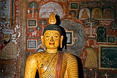 Dambulla cave temples - Cave 3, Maha Alut Viharaya (Great New Temple), behind a pair of seated Buddha's is a painting of a garden a nineteenth-century addition to the original Kandyan murals. 