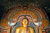 Dambulla cave temples - Cave 3, Maha Alut Viharaya (Great New Temple), The meditating  Buddha statue sits under a makara-torana where the typical makaras are replaced with white lions. 