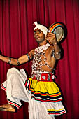 Kandyan dancing and drumming. the Raban Dance the dancer balances a number of flat drum on sticks.