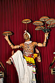 Kandyan dancing and drumming. the Raban Dance the dancer balances a number of flat drum on sticks.