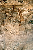Polonnaruwa - Gal Vihara. The small seated Buddha (x century), details of the reliefs in the background at the sides of the main figure.