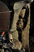 Londa - Inside the cave there is a collection of coffins, many of them rotted away, with the bones scattered or heaped in piles 