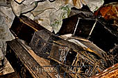 Londa - Inside the cave there is a collection of coffins, many of them rotted away, with the bones scattered or heaped in piles 