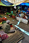 The market of Makale - stalls selling local produce including coffee, tobacco, buckets of live eels, piles of fresh and dried fish, and jugs of  'balok'