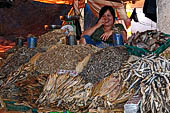 The market of Makale - stalls selling local produce including coffee, tobacco, buckets of live eels, piles of fresh and dried fish, and jugs of  'balok'