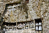 Suaya village, king's stone memorial graves, bodies placed in rock-hewn niches behind wooden effigies of the dead (known as tau tau)