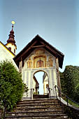 Austria, Carinzia. Klagenfurth. In bici lungo la sponda sud del Worthersee con la penisola di Maria Worth. Portale di ingresso al santuario. 