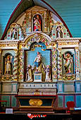 Il complesso parrocchiale, enclos, di Guimiliau. La pala d'altare del Rosario nella chiesa di San Miliau.