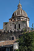 Catania - Catania - the dome of the cathedral, the merloned black lava stone walls of the transept.