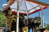 Cremation ceremony - Family members then passes ritual items up to be placed on the coffin. 