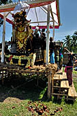Cremation ceremony - Family members then passes ritual items up to be placed on the coffin. 
