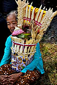 Cremation ceremony - The villagers line up, each with something to carry: holy water, ritual accessories, pyramids of food offerings piled high on their heads.