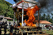 Cremation ceremony - The fuel ignites under the pyre and the splendid tower - coffin, offerings, decorations - is engulfed in flames.