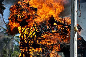 Cremation ceremony - The fuel ignites under the pyre and the splendid tower - coffin, offerings, decorations - is engulfed in flames. 