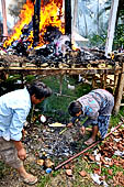 Cremation ceremony - Children are allowed to poke through the hot muddy ashes for coins and trinkets. 