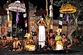 Sanghyang Dedari Dance - The two little dancers are brought out of trance by the pemangku, who prays beside them and blesses them with holy water.