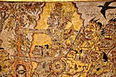 Klungkung - Bali. The Kerta Gosa palace, paintings of the lower levels. Bhatara Yamadipati followed by a group of giant and below his servants Delem and Sangut. Bhatara Yamadipati is not allowing Bhima to enter Hell.