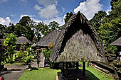 Pura Luhur Batukau - Bali - The fist courtyard. Black thatched roof pavilions. 