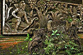 Pura Luhur Batukau - Bali - The Kulkul alarm tower, details of the scenes in the panels of the basement. 