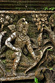 Pura Luhur Batukau - Bali - The Kulkul alarm tower, details of the scenes in the panels of the basement. 