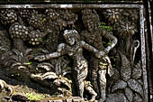 Pura Luhur Batukau - Bali - The Kulkul alarm tower, details of the scenes in the panels of the basement. 
